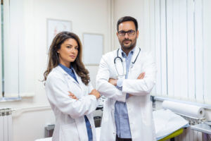 Image of two confident narcolepsy doctors working in a sleep clinic.